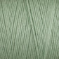 Close-up image of Great Northern Weaving's Cotton Carpet Warp 8/4 in light green, showcasing neatly wound strands. The soft and smooth texture is evident, with tightly twisted fibers forming a consistent pattern ideal for knitting, crocheting, or weaving coverlets.