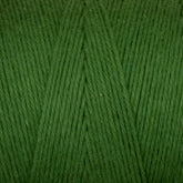 A close-up of the Great Northern Weaving Cotton Carpet Warp 8/4 reveals tightly wound, smooth yarn with a soft texture. The fibers, perfect for crafting cozy coverlets, are neatly aligned. The vibrant green shade is consistent and uniform, creating an appealing appearance.