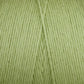 Close-up view of light green Cotton Carpet Warp 8/4 by Great Northern Weaving, showcasing the texture and alignment of the strands. The yarn is neatly wound, displaying a smooth, consistent pattern. The pastel green color creates a soft, pleasant appearance, making it perfect for crafting beautiful rag rugs or cozy coverlets.