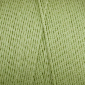 Close-up view of light green Cotton Carpet Warp 8/4 by Great Northern Weaving, showcasing the texture and alignment of the strands. The yarn is neatly wound, displaying a smooth, consistent pattern. The pastel green color creates a soft, pleasant appearance, making it perfect for crafting beautiful rag rugs or cozy coverlets.