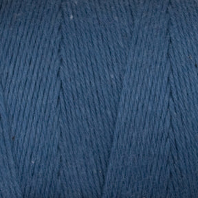 Close-up view of a spool of Great Northern Weaving's Cotton Carpet Warp 8/4 in blue. The image highlights the texture and fibers, showing the tight, even strands wound closely together. The yarn has a soft and slightly fuzzy appearance, perfect for weaving intricate coverlets or sturdy rag rugs.