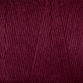 A close-up view of Great Northern Weaving's Cotton Carpet Warp 8/4 yarn, often used in rag rugs. The texture is soft and slightly fuzzy, with individual strands twisted together, creating a uniform and tightly knit pattern. The rich, deep maroon color is consistent throughout the yarn.