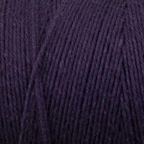 Close-up shot of Great Northern Weaving's Cotton Carpet Warp 8/4 in dark purple, showcasing its texture and tightly-wound strands. The fibers appear soft and smooth, suitable for knitting, crochet projects, or crafting coverlets.