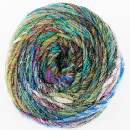 A close-up photo of a colorful skein of Noro Ito yarn from Knitting Fever / Euro Yarns, coiled into a circular shape. The yarn showcases a vibrant mix of colors including green, blue, pink, purple, and white, creating a multicolored, rainbow-like appearance against a plain white background.