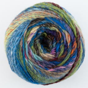 A ball of Noro Ito variegated yarn by Knitting Fever / Euro Yarns, featuring shades of blue, green, brown, orange, purple, and yellow, is intricately wound in a circular pattern. The wool worsted weight yarn appears soft and thick, making it perfect for knitting or crocheting projects. The background is plain white.