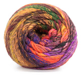 A tightly wound skein of Noro Ito by Knitting Fever / Euro Yarns showcases a blend of vibrant hues including orange, green, purple, red, and brown. The colorful yarn's texture appears soft and thick, suitable for knitting or crocheting projects.