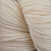 Close-up of a ball of soft, white Happy Feet Sock Yarn by Plymouth Yarn Co. with tightly wound strands creating a textured and cozy appearance. The yarn seems to be made of superwash Merino wool, featuring a smooth and slightly fluffy surface, making it perfect for durable knitting or crocheting projects.