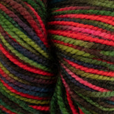 Close-up of durable Happy Feet Sock Yarn from Plymouth Yarn Co. featuring bright and vibrant shades of red, green, purple, and brown. Made from merino wool, the yarn is tightly wound, showcasing the various colors in twisted, parallel strands for a lively and textured appearance.