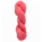 A twisted skein of Jade Sapphire Cashmere 2-Ply in bright coral, ideal for crafting colorful woven accessories, rests elegantly against a white background.