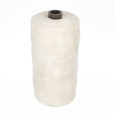 A large spool of Swedish Cotton Warp (Seine Twine, Fiskgarn) by Glimakra, showcasing a natural off-white color with a dark central core, stands upright against a white background.