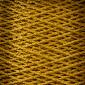 A close-up view of a neatly wound spool of 3/2 Pearl Cotton Yarn by Supreme Corp, in a golden-yellow shade. The yarn is tightly woven in an overlapping pattern, creating a textured, crisscross appearance. The fibers are slightly fuzzy, adding a soft and cozy look to the image.