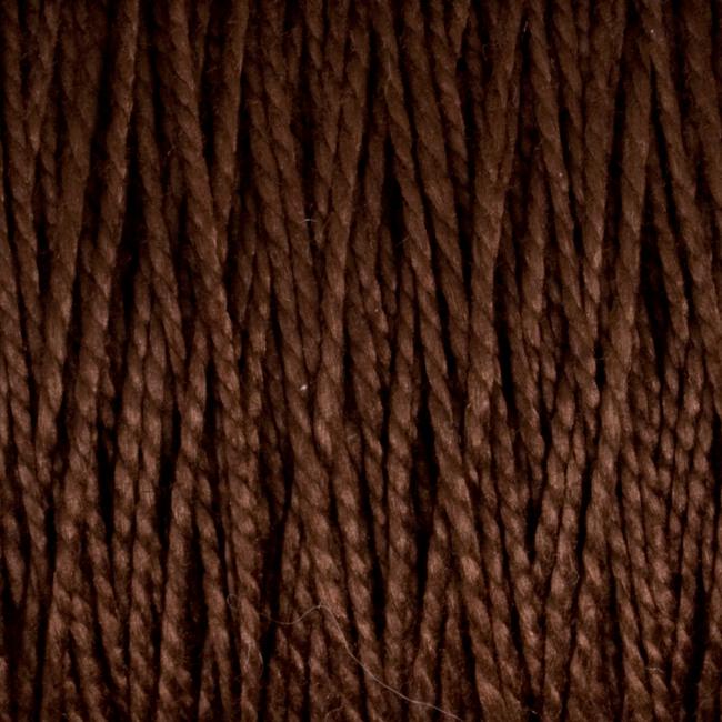 Close-up image of Supreme Corp's 3/2 Pearl Cotton Yarn on a large cone, with brown mercerized yarn strands lined up vertically, showcasing variations in texture and shading. The yarn appears thick and tightly wound, making it suitable for knitting or crocheting. This versatile yarn offers durability and a silky sheen, making it ideal for various crafting projects.