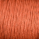 Close-up image of a spool of thick, orange-brown 3/2 Pearl Cotton Yarn. The yarn is tightly wound, showcasing its individual strands and textured surface. The lighting emphasizes the fibrous and slightly reflective quality, reminiscent of versatile yarn by Supreme Corp.