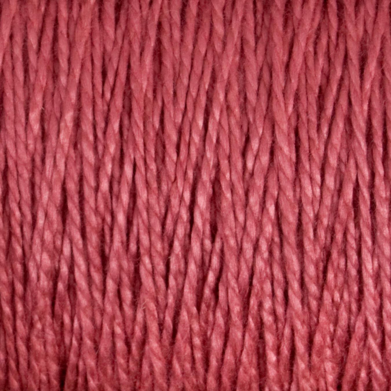 A close-up image of Supreme Corp's 3/2 Pearl Cotton Yarn strands, tightly wound together, creating a textured and uniform pattern. The fibers appear soft and slightly shiny.