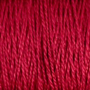 Close-up of vibrant red 3/2 Pearl Cotton Yarn from Supreme Corp tightly wound together, showcasing its smooth texture and consistent thickness. The large cone of mercerized yarn has a shiny finish, reflecting light and emphasizing its rich color and fine detail.