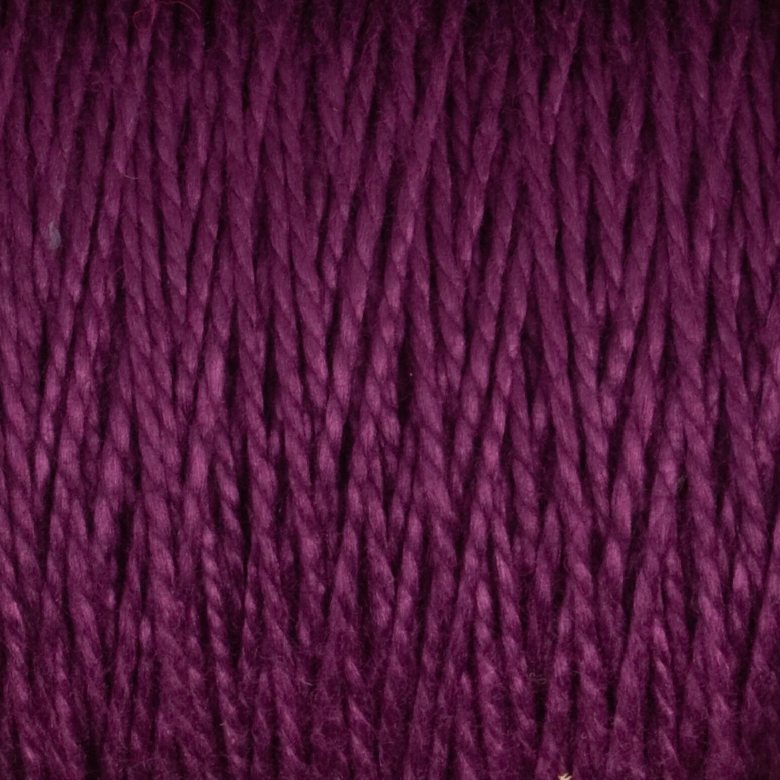 Close-up view of a skein of Supreme Corp's 3/2 Pearl Cotton Yarn on a large cone, showcasing its rich, deep purple hue. The yarn is tightly wound in neat, parallel rows, displaying a soft and slightly glossy texture. Individual strands of the versatile yarn are clearly visible.