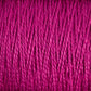 Close-up image of tightly wound, vibrant magenta-colored 3/2 Pearl Cotton Yarn by Supreme Corp on a large cone, with visible texture and strands. The mercerized cotton yarn appears smooth and slightly glossy, showcasing a rich, consistent hue.