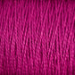 Close-up image of tightly wound, vibrant magenta 3/2 Pearl Cotton Yarn | Mini-cone from Supreme Corp. The texture of the versatile yarn is visible, showcasing individual fibers twisted together to form a thick, coarse strand. The image highlights the consistent, intertwined pattern of the yarn fibers.