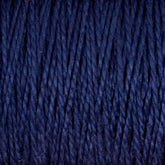 Close-up of dark blue, 3/2 Pearl Cotton Yarn from Supreme Corp. The mercerized cotton fibers appear tightly woven and have a subtle sheen, giving the yarn a smooth, almost glossy texture. The deep navy blue color is consistent throughout the image.