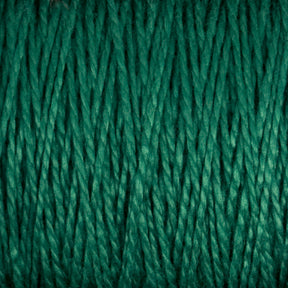 Close-up image of the 3/2 Pearl Cotton Yarn from Supreme Corp, tightly wound and highlighting its texture and fibers. The yarn is uniformly colored in a vibrant shade of green, suggesting a high-quality blend that might include versatile or mercerized cotton properties.