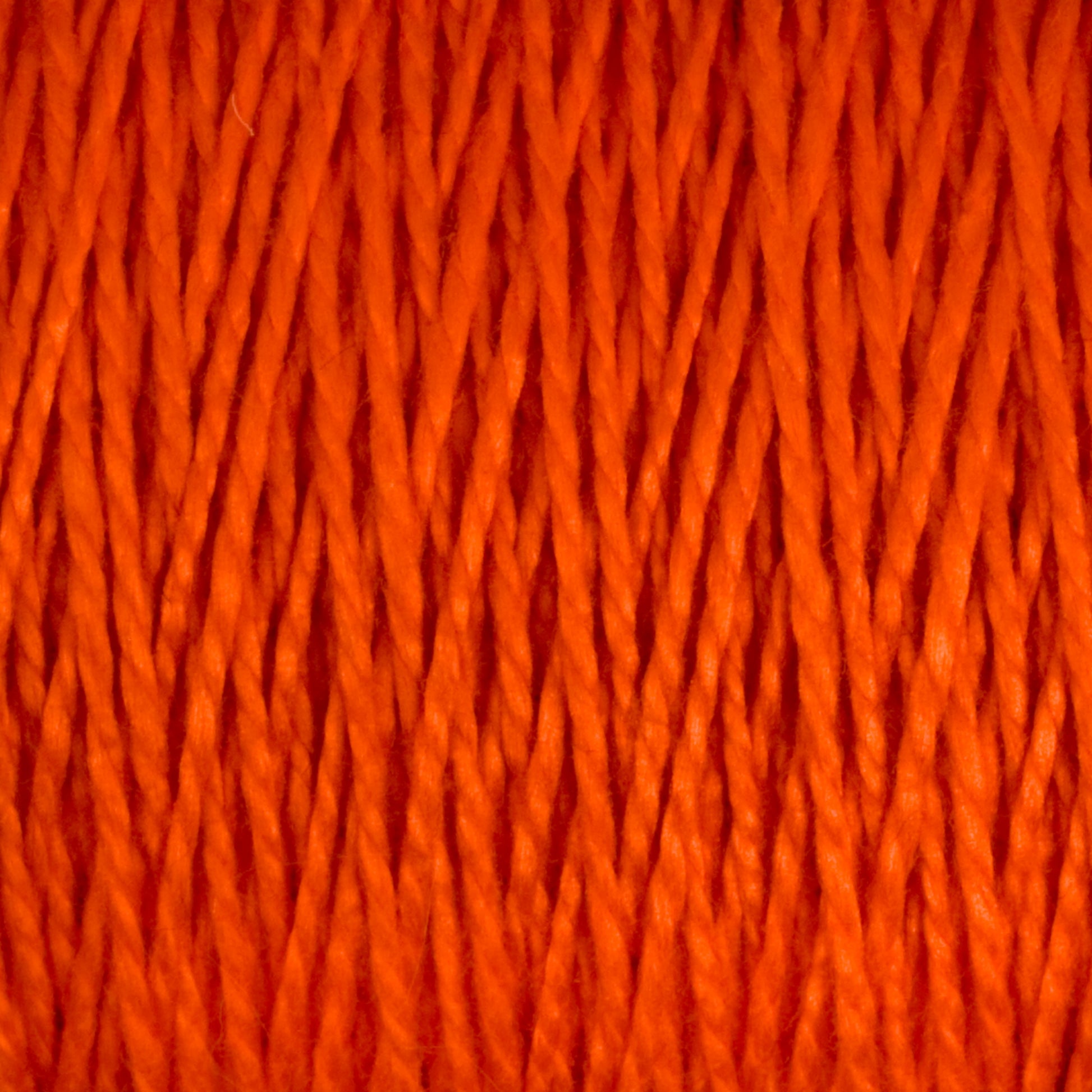 Close-up image of a bundle of bright orange 3/2 Pearl Cotton Yarn from Supreme Corp. The tightly twisted fibers create a textured and dense pattern. The vibrant color and texture are prominently featured in the photograph, enhancing the appeal of this Mini-cone yarn.