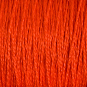 A close-up view of 3/2 Pearl Cotton Yarn | Large Cone by Supreme Corp reveals orange-threaded, mercerized cotton yarn with tightly packed vertical strands, creating a textured pattern. The rich hue of orange is consistent throughout the image, showcasing the detailed fibers and smooth appearance of this versatile yarn.