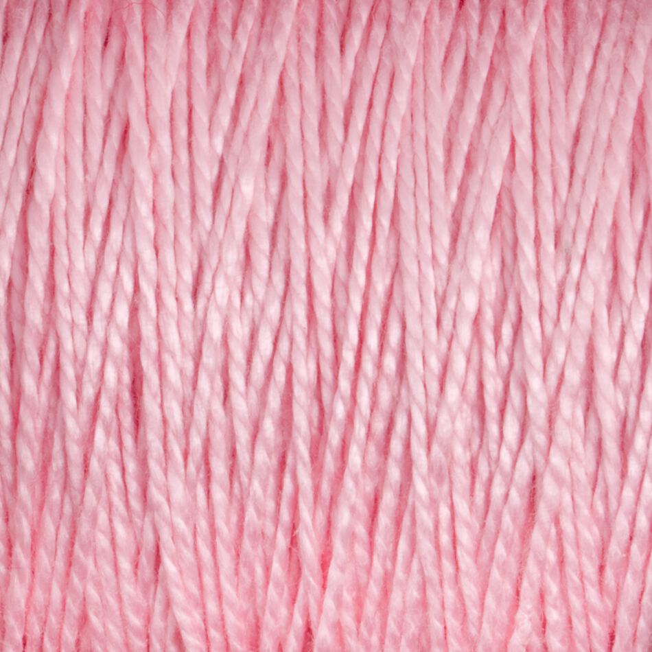 A close-up view of the 3/2 Pearl Cotton Yarn | Large Cone from Supreme Corp, showcasing its smooth and tightly woven texture. The pink, mercerized fibers have a slight sheen, creating a soft, pastel appearance.