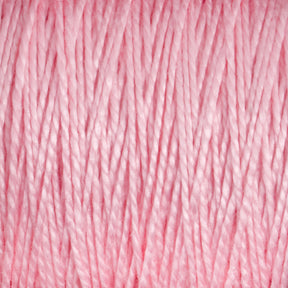 Close-up of light pink Supreme Corp's 3/2 Pearl Cotton Yarn mini-cone strands tightly wound together. The texture appears soft and slightly shiny, with individual fibers clearly visible, creating a uniform pattern throughout the image.