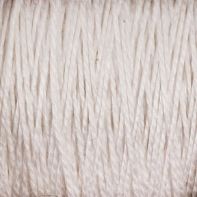 Close-up shot of tightly wound white 3/2 Pearl Cotton Yarn on a Mini-cone by Supreme Corp, highlighting its fibrous texture and subtle variations in color. The versatile yarn appears soft and durable, suitable for crafting or packaging.