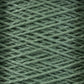 Close-up image of Supreme Corp's 3/2 Pearl Cotton Yarn from the Large Cone, wound in a criss-cross pattern, creating a textured and detailed surface. The fibers appear soft and slightly fuzzy, suggesting a comfortable and cozy material. This versatile yarn, made of mercerized cotton, offers a consistent green color for a uniform appearance.