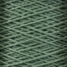 Close-up image of Supreme Corp's 3/2 Pearl Cotton Yarn from the Large Cone, wound in a criss-cross pattern, creating a textured and detailed surface. The fibers appear soft and slightly fuzzy, suggesting a comfortable and cozy material. This versatile yarn, made of mercerized cotton, offers a consistent green color for a uniform appearance.