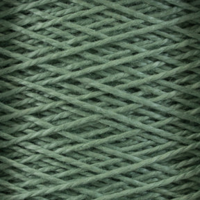 Close-up image of Supreme Corp’s 3/2 Pearl Cotton Yarn | Mini-cone in a vibrant green hue, wound tightly in a crisscross pattern to create a textured and interwoven appearance. The yarn is neatly wrapped, showcasing the soft and fibrous material.