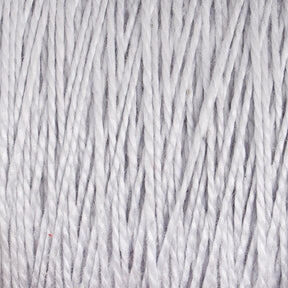 Close-up image of tightly wound, soft, white 3/2 Pearl Cotton Yarn from Supreme Corp. The fibers are evenly aligned, creating a textured and cozy appearance. This mercerized cotton yarn has a slight sheen, highlighting its smooth and delicate texture on the mini-cone.