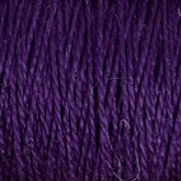 Close-up image of deep purple, 3/2 Pearl Cotton Yarn | Mini-cone by Supreme Corp, twisted into tightly wound strands. There are a few small, stray fibers around the edges. The texture appears soft, and the color is rich and consistent throughout this versatile yarn.