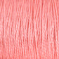 Close-up image of a tightly wound spool of pink 3/2 Pearl Cotton Yarn from Supreme Corp, showcasing the texture and uniformity of the individual strands. The mercerized cotton yarn has a soft appearance with subtle variations in shading.