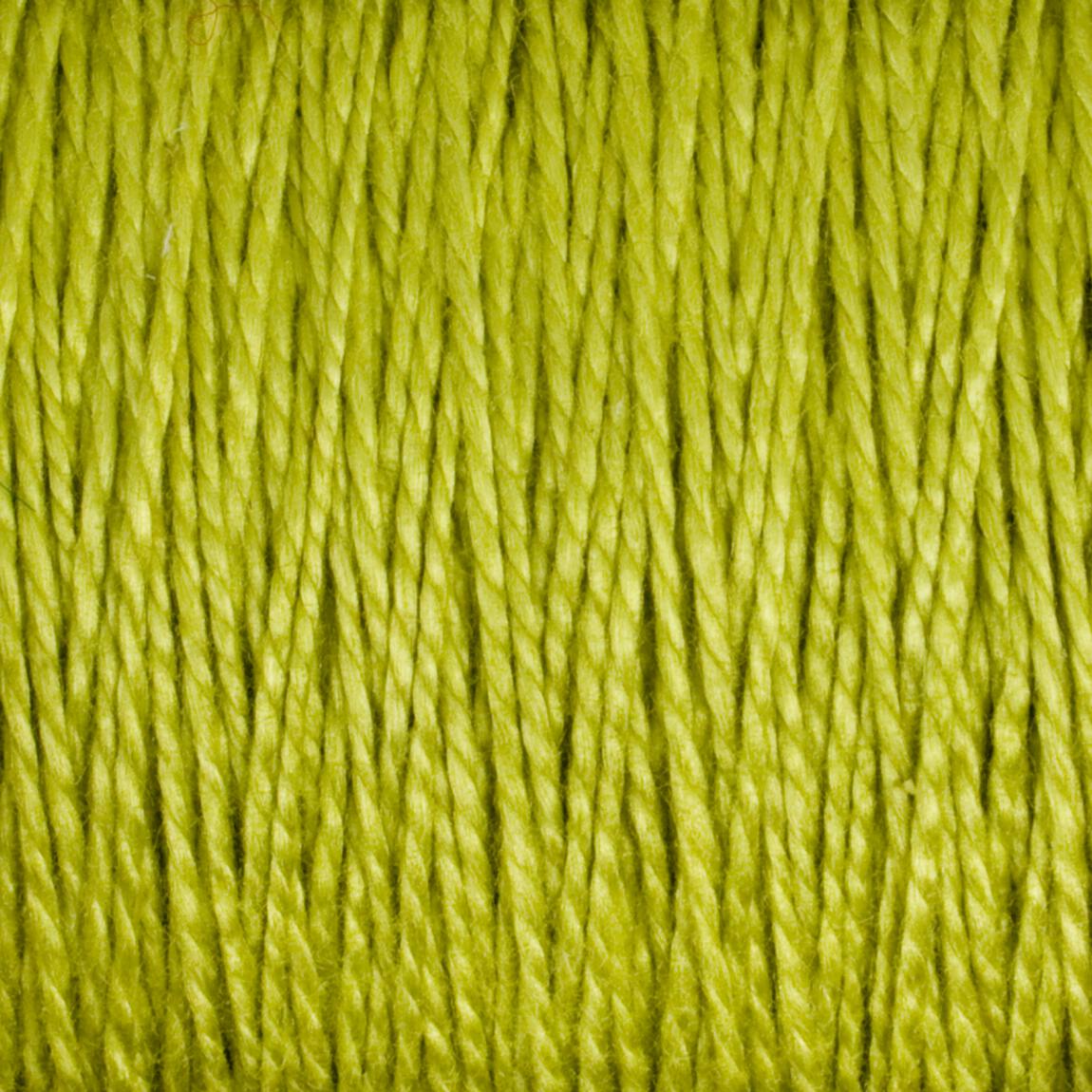 Close-up image of strands of bright green 3/2 Pearl Cotton Yarn from Supreme Corp, densely packed together, creating a textured and vibrant pattern. The fibers appear smooth and slightly shiny, showcasing the intricate and uniform weave of this versatile Large Cone yarn.