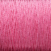 Close-up image of a spool of pink thread, showcasing the texture and tightly wound strands. The 3/2 Pearl Cotton Yarn from Supreme Corp appears to be made from mercerized cotton, with a slightly shiny surface, and is tightly packed together on a large cone.