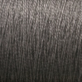 A close-up of tightly wound dark gray 3/2 Pearl Cotton Yarn from Supreme Corp. The texture and details of the individual strands are clearly visible, showcasing a smooth and consistent weave pattern. The overall appearance resembles a dense, uniform spool of versatile yarn on a large cone.