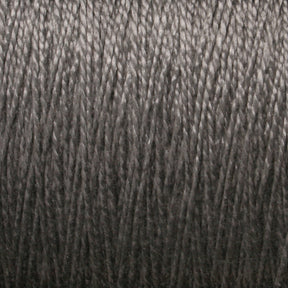 A close-up of tightly wound dark gray 3/2 Pearl Cotton Yarn from Supreme Corp. The texture and details of the individual strands are clearly visible, showcasing a smooth and consistent weave pattern. The overall appearance resembles a dense, uniform spool of versatile yarn on a large cone.