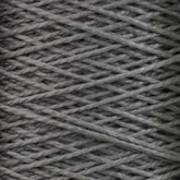 Close-up view of a ball of Supreme Corp's 3/2 Pearl Cotton Yarn | Large Cone with a textured surface. The yarn is wound tightly, creating a crisscross pattern. The fibers appear thick and slightly fuzzy, showcasing the detailed texture of the material.