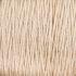 Close-up view of a spool of 5/2 Pearl Cotton Yarn in beige or light tan from Supreme Corp, showing tightly wound fibers. The texture of this versatile yarn is visible, providing a detailed look at the individual strands that comprise the large cone. The background is out of focus, emphasizing the thread.