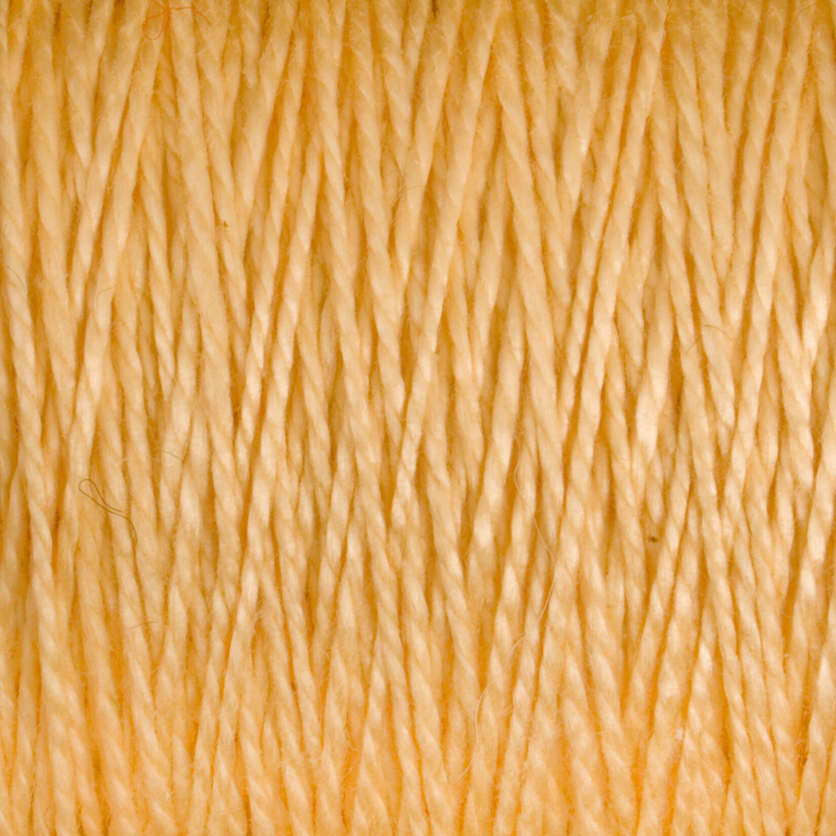 Close-up image of Supreme Corp's 5/2 Pearl Cotton Yarn in a light yellow hue, tightly wound together on a large cone, creating a textured and uniform appearance.