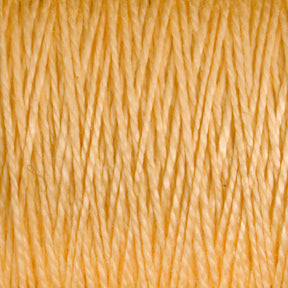 Close-up image of Supreme Corp's 5/2 Pearl Cotton Yarn in a light yellow hue, tightly wound together on a large cone, creating a textured and uniform appearance.