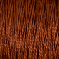 Close-up of a textured surface showing tightly wound, thick strands of brown 5/2 Pearl Cotton Yarn by Supreme Corp. The fibers twist and intertwine, creating a dense and prominent pattern. The lighting highlights the texture and depth of the versatile yarn from the Large Cone, reminiscent of finely spun Pearl Cotton.