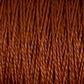 A close-up shot showcases the tightly wound, rust-colored 5/2 Pearl Cotton Yarn from Supreme Corp. The mercerized cotton fibers are twisted and display a rich, earthy brown hue, forming a dense and textured pattern. The focus on the details of the individual strands and their interwoven structure makes this mini-cone yarn perfect for weaving projects.