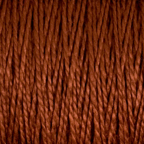 A close-up shot showcases the tightly wound, rust-colored 5/2 Pearl Cotton Yarn from Supreme Corp. The mercerized cotton fibers are twisted and display a rich, earthy brown hue, forming a dense and textured pattern. The focus on the details of the individual strands and their interwoven structure makes this mini-cone yarn perfect for weaving projects.