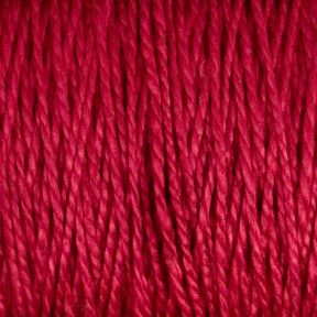 Close-up image of a bundle of tightly wound 5/2 Pearl Cotton Yarn from Supreme Corp. The yarn, displayed on a large cone, features a smooth texture with a slight shine. The individual strands are clearly visible, creating an intricate pattern of vertical lines in vibrant red.