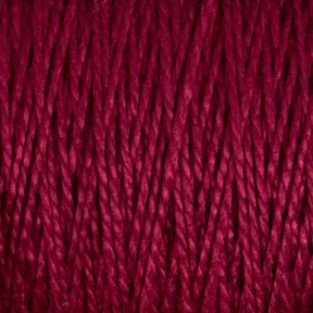 Close-up image of thick, red 5/2 Pearl Cotton Yarn from Supreme Corp, tightly wound in a parallel pattern on a large cone. The yarn has a rich, deep color and a slightly shiny texture, revealing individual twisted strands that provide a sense of both warmth and softness.