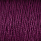 Close-up view of a purple skein of Supreme Corp's 5/2 Pearl Cotton Yarn | Large Cone, showcasing its tightly wound, fibrous texture and rich color. The strands are neatly aligned, emphasizing the material's smooth and soft appearance.