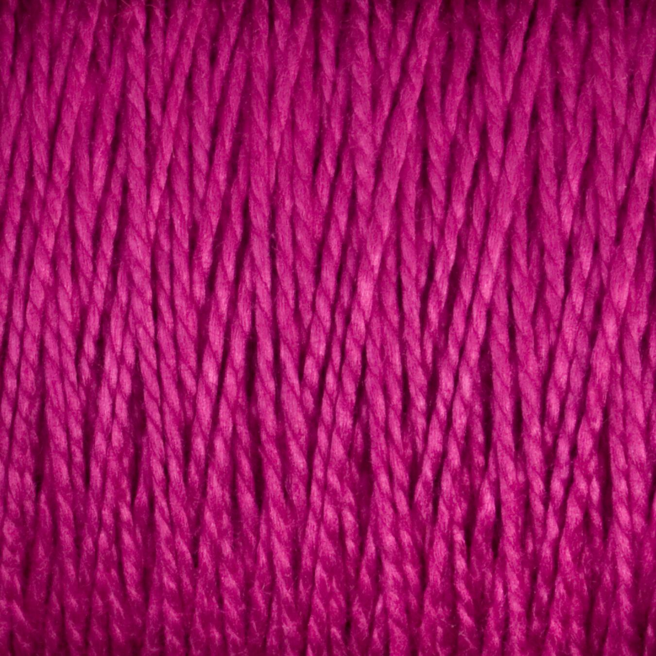 Close-up image of a tightly wound spool of 5/2 Pearl Cotton Yarn from Supreme Corp. The texture is clearly visible, showcasing the intertwined fibers and slight sheen of this versatile material. The vibrant magenta hue is prominent throughout the large cone.